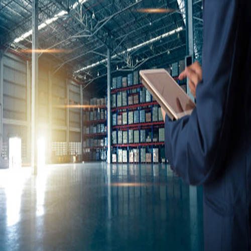 Businessman manager using tablet check and control for workers with Modern Trade warehouse logistics. Industry 5.0 concept
