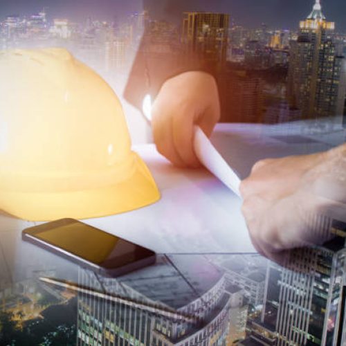 Double exposure of city and the engineering discussion with blueprint on the desk., Construction management  Infrastructure plan guidelines concept