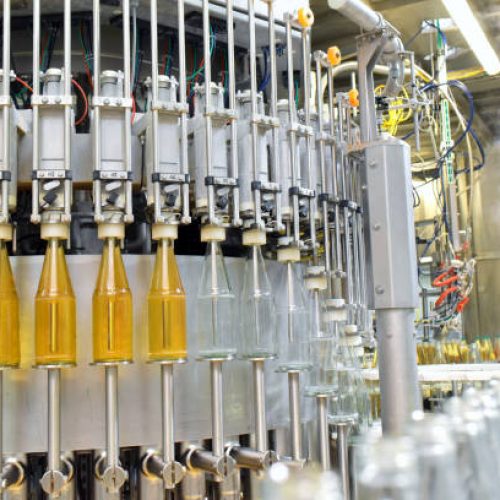 apple juice in glass bottles in a factory for the food industry - bottling and transport