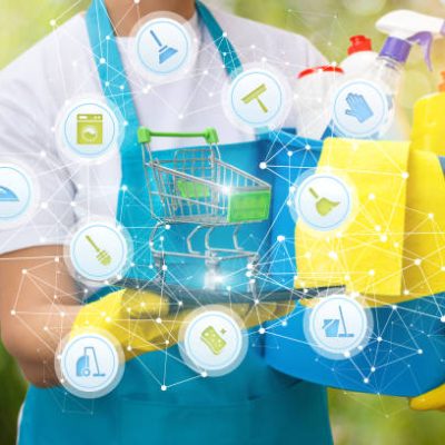 Cleaning lady shows the shopping cart on the tablet. The concept of The store household chemicals.